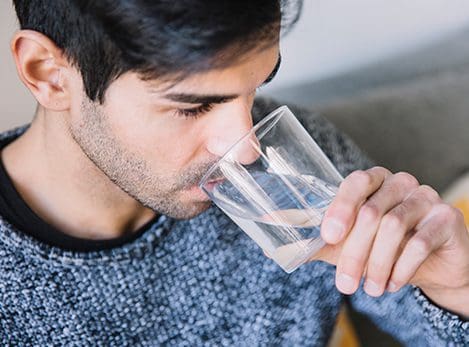Man drinking fresh purified water
